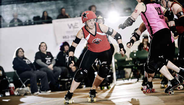 Roller Skating women in action during a North Star Roller Derby bout.