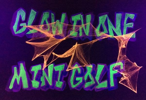 Picture: Glow in One Mini Golf sign with Halloween cobwebs